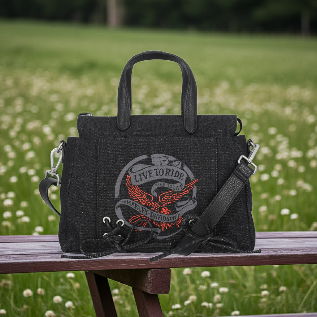 black satchel bag sitting on picnic table